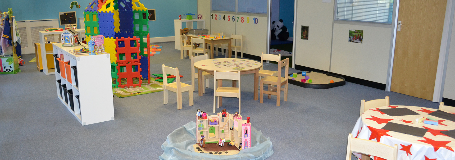 Bright playroom with tables, chairs and building toys
